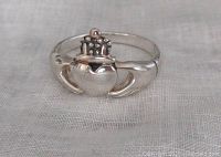 Front view of the sterling silver Claddagh ring showing heart, crown, and hands design on a light background.