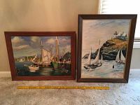 Two framed acrylic paintings by W. Messer, nautical themed, with measuring yardstick for scale.
