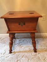 Full front view of the wooden topside table showing turned legs and front decorative metal pull.