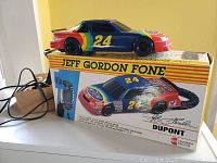 Jeff Gordon 24 racecar telephone displayed on top of its original box with branding and image details.