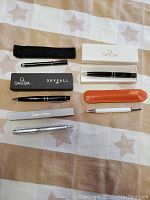 All pens and their original boxes or cases laid out showing branding and conditions