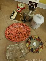 Wide shot of all vintage and retro kitchen items including clock, can opener, coffee maker, cookie jar, and trays