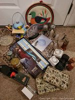 Overview of the assorted vintage household items including kitchenware, decorative pot holders, glassware, and small appliances.