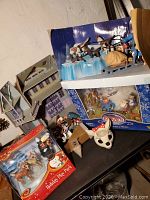 Assorted boxed playsets and mask displayed on table