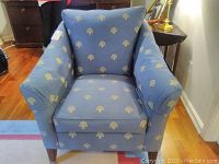 Front view of the blue upholstered Ethan Allen armchair showing patterned fabric and seat and back cushions.