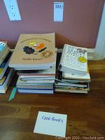 Stack of various cook books including Moosewood Cookbook and others
