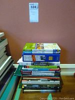Stack of assorted travel books from Frommer's, Moon Travel Guides, and others on a table against a brown wall.