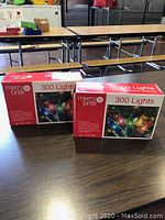 Two boxes of MerryBrite 300 lights on a table, showing original packaging with product information.