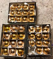 35 vintage large shiny gold spherical Christmas tree ornaments in three original boxes with partitioned compartments.