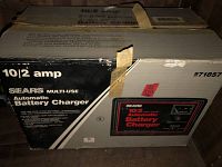 Box front and top show 10/2 amp Sears multi-use automatic battery charger with taped box and sale tag.