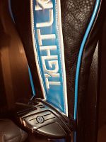 Close-up of Tight Lies branded leather and blue material head cover with 5 wood club head partially visible at base.