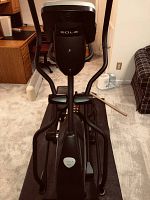 Front view of elliptial trainer on rubber mat in basement room