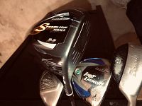 Photo showing the Titleist Speedline 9064 LS driver, Tour Edge Hot Launch 2 driver, and two other metal clubs grouped together.