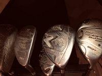 Close view of Callaway golf iron and King Cobra Baffler Power 20° wood club heads showing wear and brand logos.