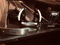 Photo showing the putter heads including an Avanter Golf Etern and STX ProFit putter along with a black leather headcover.