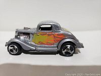 Front angle view of the silver vintage Hot Wheels toy car showing flame decals.