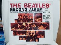 Front cover of The Beatles' Second Album vinyl record showing collage of band member photos and album title text.
