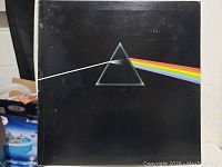 Front cover of Pink Floyd The Dark Side Of The Moon vinyl record album showing the iconic prism and rainbow light design
