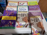 Top-down view of 10 Roald Dahl books laid out on a table showing cover art and titles.