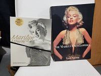 Two hardcover Marilyn Monroe books: one is the 50th Anniversary Edition book paired with a DVD set, the other is The Marilyn Encyclopedia with a gold dress cover photo.