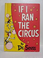Front cover of the 1956 first edition Dr. Seuss book 'If I Ran The Circus' featuring red and yellow background with circus performers.