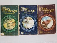Front covers of three Lord of the Rings second edition paperbacks, showing colorful circular illustrations and book titles in gold lettering on green, blue, and brown backgrounds.
