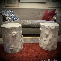Two gray bark-effect resin side tables in front of a gray couch