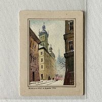 Photo showing the entire watercolour painting mounted on a mat board against a fabric background. The scene depicts an old European city street with church towers and a person near a streetcar.