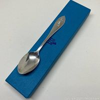 Teacher's sterling silver spoon in blue Birks gift box, showing overall presentation.