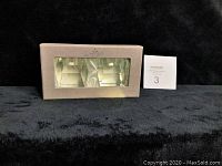 Box with two crystal candlesticks visible through window, showing original packaging condition.