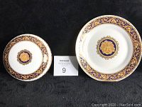 Top view of plate and bowl showing Medusa design with gold and blue decorative borders