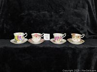 Eight vintage bone china teacups and saucers arranged in a row, showing varied floral designs.
