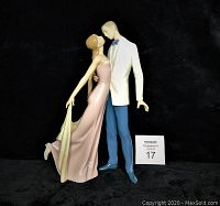 Front view of the Lladró dancing couple figurine on black cloth with lot card