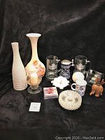 Full lot with all glass and ceramic items including vases, beer steins, candle holder, ashtray, and wooden figurine on black backdrop