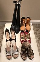 View of all six pairs of shoes including boots, boots, heeled shoes, sandals, flats, wedges
