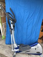 Full side view of blue and gray FreeSpirit elliptical machine with dual-action handlebars and foot pedals