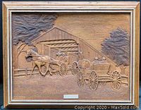 Full view of the carved wooden artwork showing detailed horses and carriages approaching a covered wooden bridge within a wood frame.