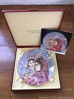 Plate displayed inside original collector's case with booklet.