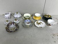 Overview of all tea related china items including cups, saucers, creamer and sugar bowl