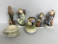 Group photo of six ceramic vintage figurines and decorative pieces showing variety and wear