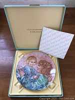 Collector plate in original box with certificate or booklet inside.