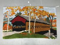 Full view of vintage hand hooked rug depicting covered bridge and fall foliage