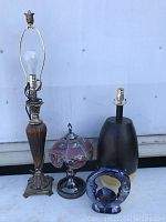 Full view showing three lamps and one ceramic candle holder