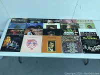 Full lot arrangement on table showing 18 vintage country and crooners LPs with visible album covers