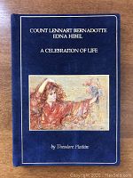 Front cover of the vintage blue hardcover book titled 'COUNT LENNART BERNADOTTE EDNA HIBEL A CELEBRATION OF LIFE' with artwork of a woman holding flowers in a painterly style.