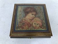 Top view of wooden keepsake music box showing Edna Hibel art of mother and child under glass inlaid on lid