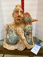 Front view of the sculpture showing the lady and the kingfisher, size approximately 14 inches tall.