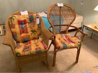 Two rattan and wicker style chairs placed side by side with yellow patterned cushions in a bedroom setting.