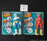 Front view of two sealed Retro-Action DC Super Heroes figures: Captain Cold and The Flash, in original blister card packaging.