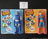 Front view of two sealed action figures, Darkseid on left with blue packaging and Superman on right with yellow packaging.